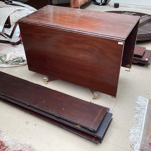 540 - A mahogany circular pedestal table, with extension leaves with pedestal base, and a mahogany drop le... 