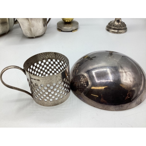 112 - A collection of sterling silver and white metal items to include three piece tea set a boxed pair of... 