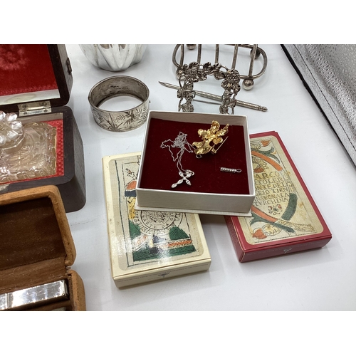 112 - A collection of sterling silver and white metal items to include three piece tea set a boxed pair of... 