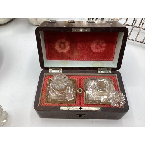 112 - A collection of sterling silver and white metal items to include three piece tea set a boxed pair of... 