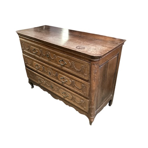 636 - Continental oak chest of three long drawers, the front carved with swags, marks and condition (see p... 