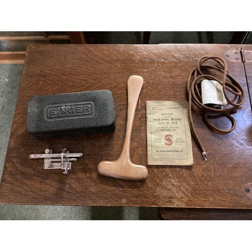 637 - Vintage treadle Singer sewing machine and table, together with various parts and instruction manual