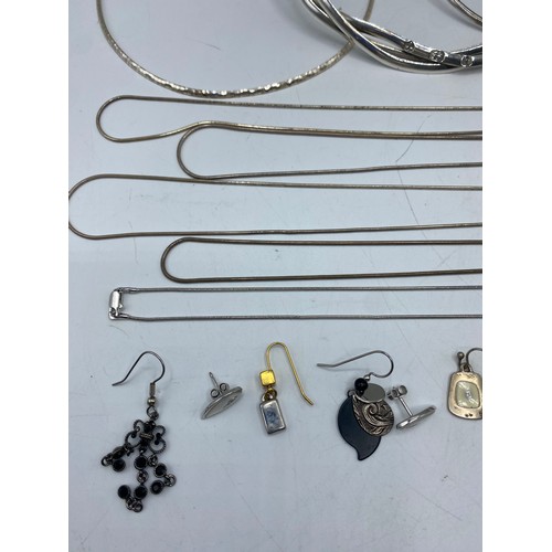 61 - A collection of sterling silver and white metal jewellery to include torques, earrings, pendants, ne... 