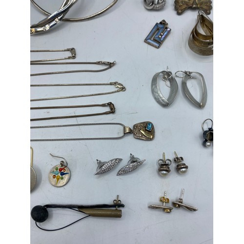 61 - A collection of sterling silver and white metal jewellery to include torques, earrings, pendants, ne... 