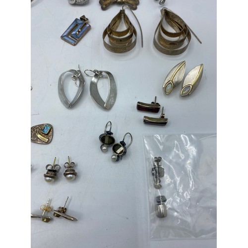 61 - A collection of sterling silver and white metal jewellery to include torques, earrings, pendants, ne... 