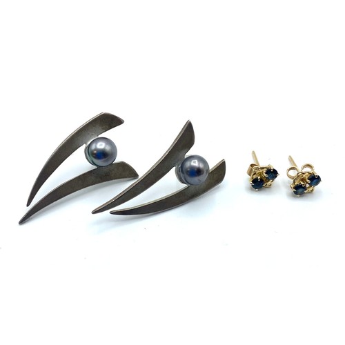 60 - A pair of unmarked yellow metal earrings each mounted with two single cut sapphires together with a ... 