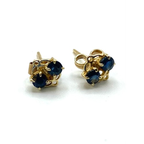 60 - A pair of unmarked yellow metal earrings each mounted with two single cut sapphires together with a ... 