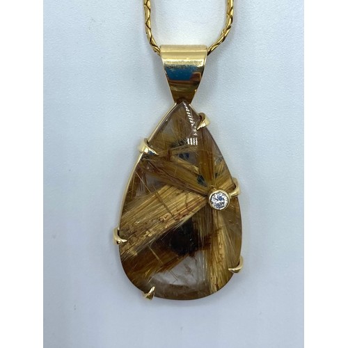 47 - a rutilated quartz pendant in unmarked yellow metal mount with single bezel set brilliant cut diamon... 