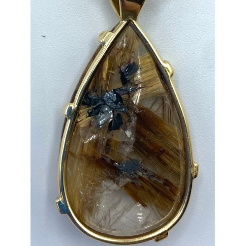 47 - a rutilated quartz pendant in unmarked yellow metal mount with single bezel set brilliant cut diamon... 