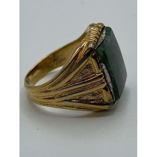 48 - An unmarked yellow metal ring set with rectangular nephrite plaque, 9.6 g, size V