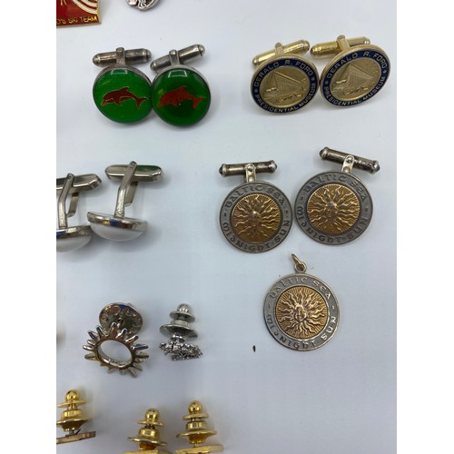 54 - A collection of yellow and white metal cufflinks, tie pins and lapel badges together with a pair of ... 