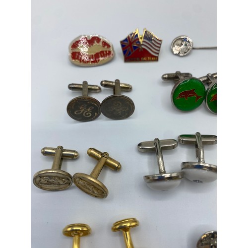 54 - A collection of yellow and white metal cufflinks, tie pins and lapel badges together with a pair of ... 