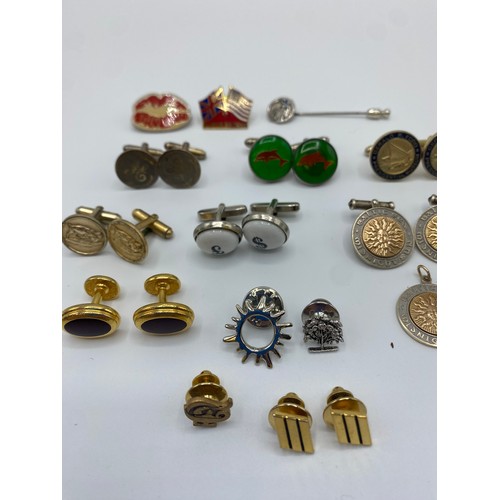 54 - A collection of yellow and white metal cufflinks, tie pins and lapel badges together with a pair of ... 