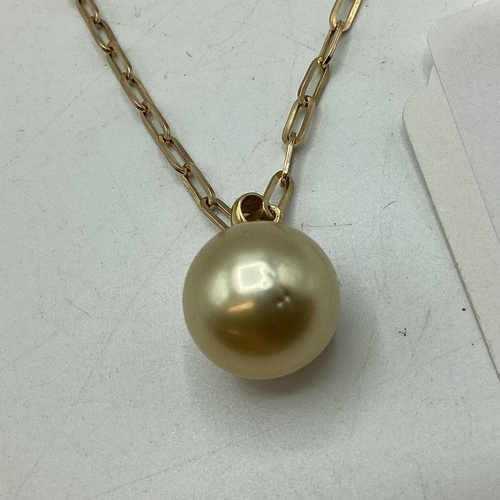 10 - A single golden pearl pendant on 18ct gold bale. Approx 13mm on 9ct gold chain necklace. 46cm. 5.2g.