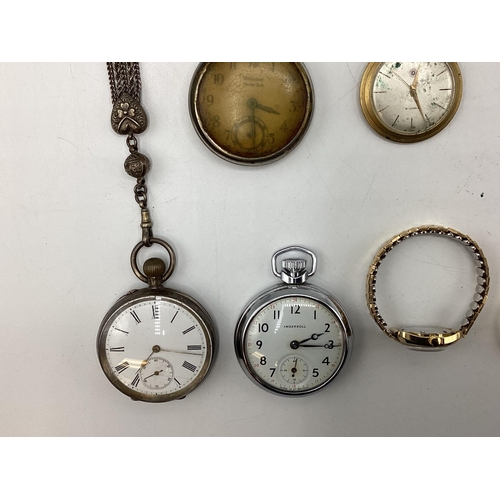 108 - A collection of watches and time pieces to include a 935 silver cased key wind pocket watch