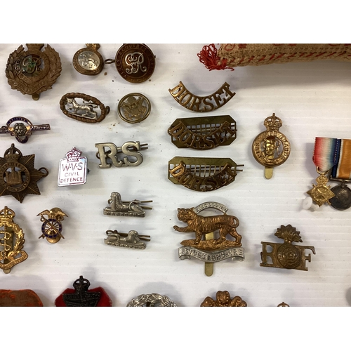 207 - A large collection of military cap badges, various regiments together with a collection of military ... 