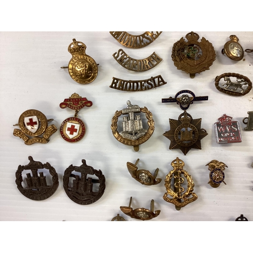 207 - A large collection of military cap badges, various regiments together with a collection of military ... 