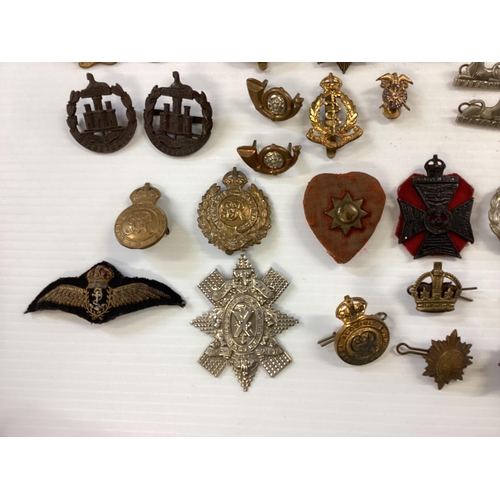 207 - A large collection of military cap badges, various regiments together with a collection of military ... 