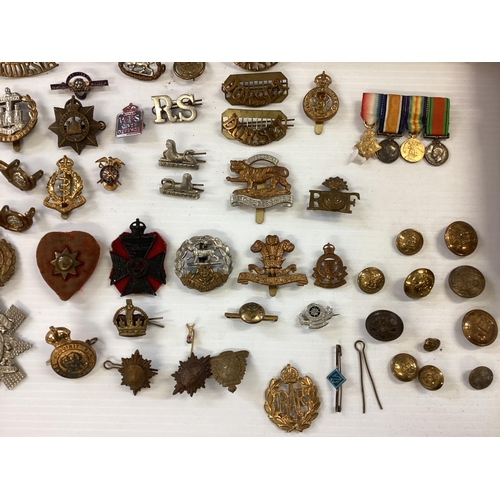 207 - A large collection of military cap badges, various regiments together with a collection of military ... 