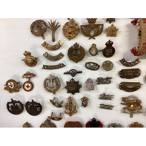 207 - A large collection of military cap badges, various regiments together with a collection of military ... 