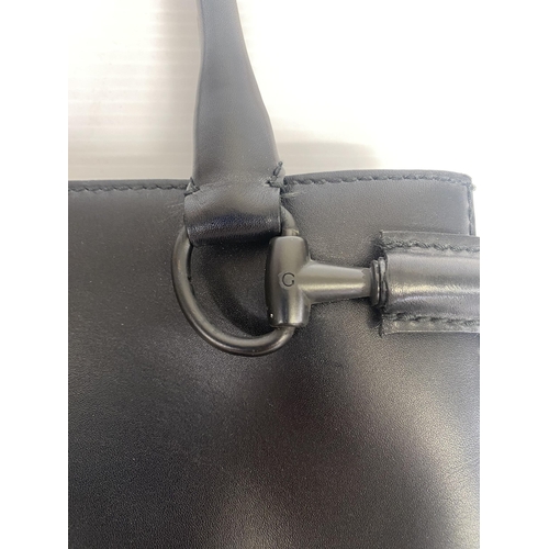 251 - GUCCI, black shoulder bag, number 101345001013, and a Gucci dust cover bag Condition, some wear, see... 