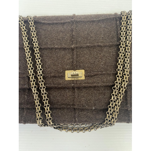 254 - CHANEL, a brown fabric handbag, with original authentication card in envelope, number 5834568, and a... 