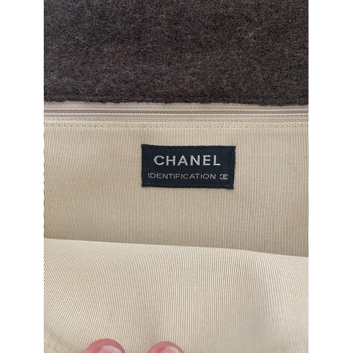 254 - CHANEL, a brown fabric handbag, with original authentication card in envelope, number 5834568, and a... 