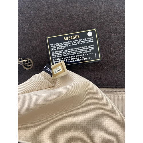 254 - CHANEL, a brown fabric handbag, with original authentication card in envelope, number 5834568, and a... 