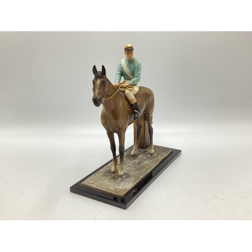 422 - A cold painted spelter match striker in the form of a horse and jockey on black onyx style base. 18c... 