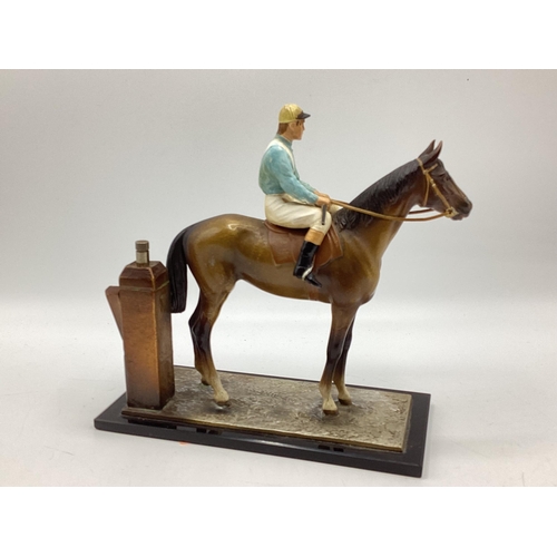 422 - A cold painted spelter match striker in the form of a horse and jockey on black onyx style base. 18c... 