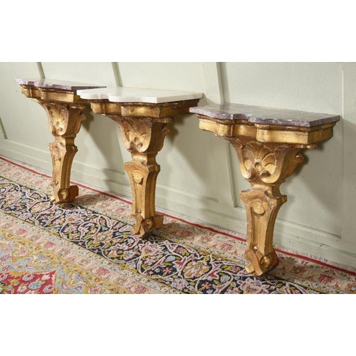 460 - A NEAR SET OF THREE GILTWOOD AND MARBLE TOPPED CONSOLE TABLES ITALIAN, INCORPORATING 19TH CENTURY EL... 