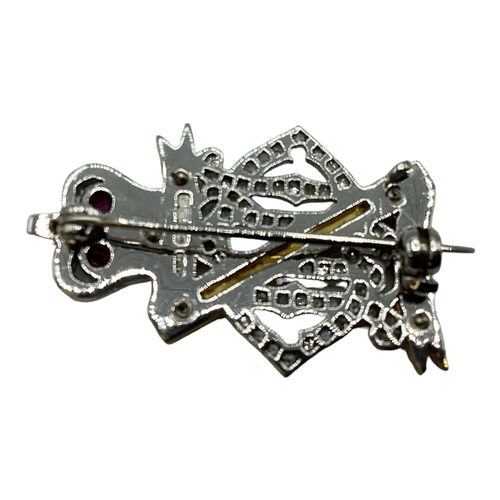 74 - An 18ct white gold diamond ruby and enamel regimental sweethearts brooch for Royal Hussars, set thro... 