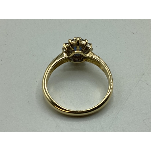 91 - A 18ct gold sapphire and diamond ring. Central oval free cut sapphire with a surround of 12 single c... 