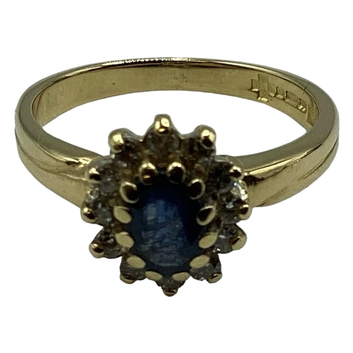 91 - A 18ct gold sapphire and diamond ring. Central oval free cut sapphire with a surround of 12 single c... 