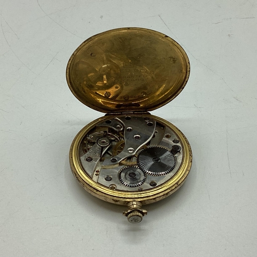 94 - A yellow metal crown wind pocket watch by tempo with engine turned face.