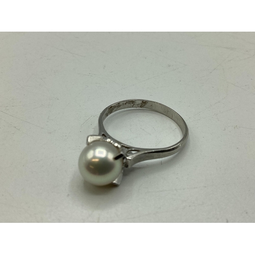 95 - A platinum and single pearl ring. 8mm single pearl in a four claw setting. Size L. 4.3g.