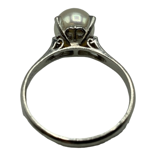 95 - A platinum and single pearl ring. 8mm single pearl in a four claw setting. Size L. 4.3g.