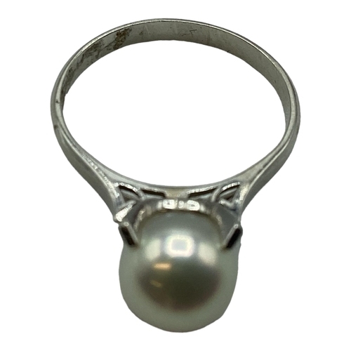 95 - A platinum and single pearl ring. 8mm single pearl in a four claw setting. Size L. 4.3g.