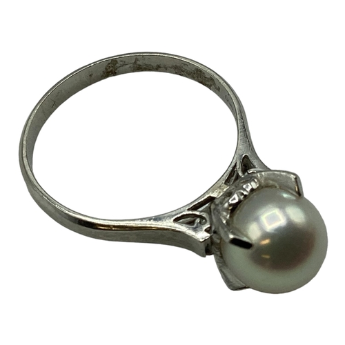 95 - A platinum and single pearl ring. 8mm single pearl in a four claw setting. Size L. 4.3g.