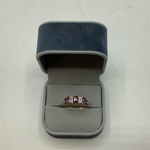 96 - A 9ct gold amethyst and diamond ring . Three oval free cut amethysts with single cut diamond accents... 