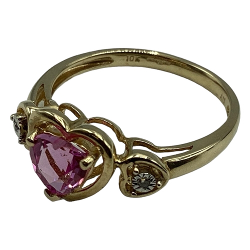 97 - A 10ct gold pink sapphire and diamond ring. Central heart cut sapphire with illusion set single cut ... 