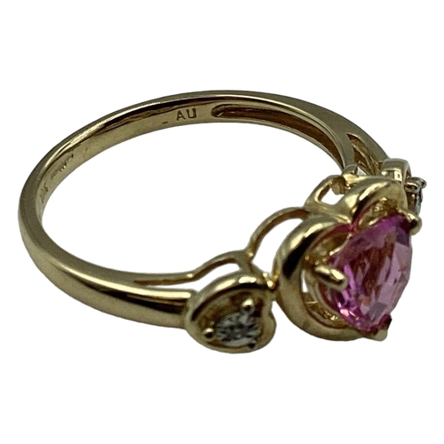 97 - A 10ct gold pink sapphire and diamond ring. Central heart cut sapphire with illusion set single cut ... 