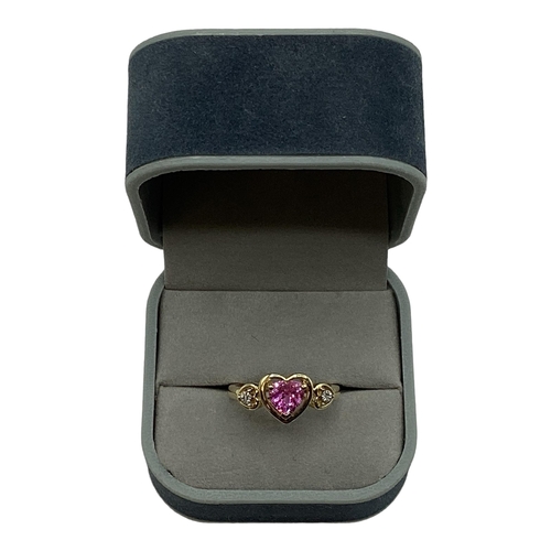 97 - A 10ct gold pink sapphire and diamond ring. Central heart cut sapphire with illusion set single cut ... 