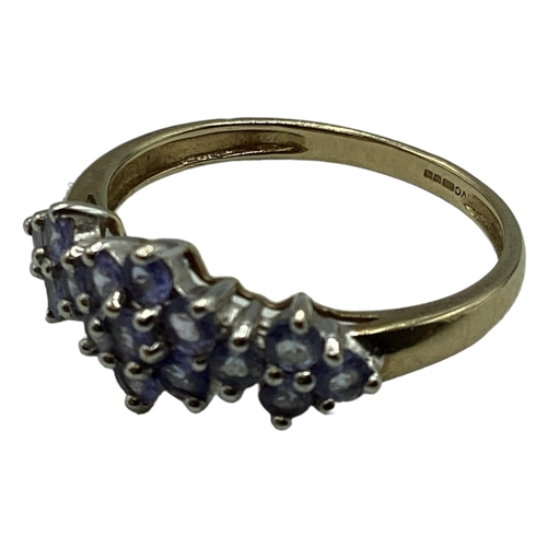 98 - A 9ct gold and tanzanite cluster ring. Size T. 2.4g.