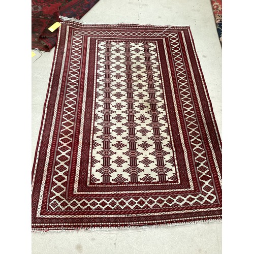 713 - Two Persian style rugs, one with cream and red all over stylized design with some stains, 187cm x 13... 