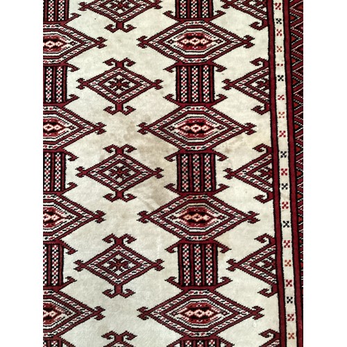 713 - Two Persian style rugs, one with cream and red all over stylized design with some stains, 187cm x 13... 