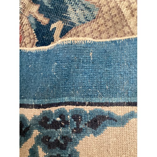 709 - A blue and oatmeal coloured rug, with all over stylized design, dragons illustrated to each corner, ... 