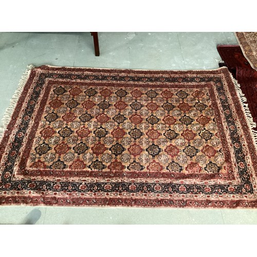 701 - FIVE rugs: A red ground Persian style rug, 158 x 102cm; another with brown ground and  central navy ... 