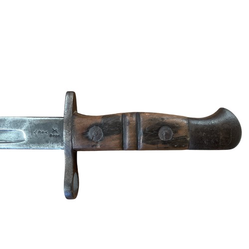 191 - A 1913 pattern Remington bayonet with scabbard and frog. 55cm together with a British stick bayonet.