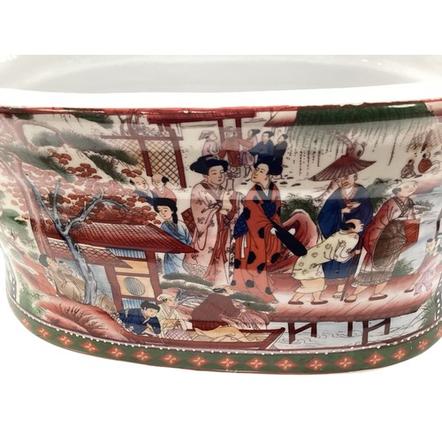 355 - A two handled china footbath with the Chinese Famille rose pattern; and a Chinese two handled porcel... 